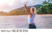 Happy blond beautiful women raising her hands on Ao Nang beach at sunset, Krabi Thailand (2016 год). Стоковое фото, фотограф Igor Tichonow / Фотобанк Лори