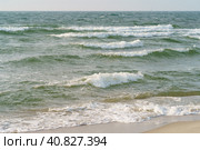 Photography of different blue colors of  surf of Baltic sea. Restless sea before storm. Waves going onto sandy beach. Natural fresh background, web banner, postcard. Concept of the strength in nature. Стоковое фото, фотограф YuryKara / Фотобанк Лори