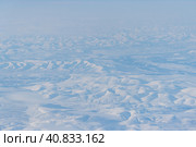 Aerial view of snow-capped mountains. Winter snowy mountain landscape. Icheghem Range, Kolyma Mountains. Koryak Okrug (Koryakia), Kamchatka Krai, Siberia, Far East of Russia. Great for backgrounds. Стоковое фото, фотограф Андрей Степанов / Фотобанк Лори