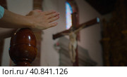 Close-up woman folded hands in prayer near the cross with the crucified Jesus Christ the Redeemer. Стоковое фото, фотограф Ольга Сухарева / Фотобанк Лори
