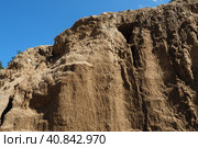Sandstone is a fragmentary sedimentary rock, a homogeneous or layered aggregate of fragmentary grains and grains of sand bound by any mineral substance, cement. Quarry natural yellow sand wall. Стоковое фото, фотограф Юлия Петровская / Фотобанк Лори
