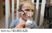 Sick Baby Girl with making Inhalation with a Mask on his Face sitting in Living Room at Home. Children Healing. Child Inhalation therapy with Compressor nebulizer. Inhaling fumes medication into lungs. Стоковое видео, видеограф Марина Демидюк / Фотобанк Лори