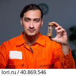 Young convict man sitting in dark room. Стоковое фото, фотограф Elnur / Фотобанк Лори