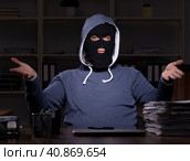 Male thief in balaclava in the office night time. Стоковое фото, фотограф Elnur / Фотобанк Лори
