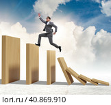 Businessman in domino effect concept. Стоковое фото, фотограф Elnur / Фотобанк Лори