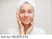 portrait of gorgeous happy middle age woman looking at mirror touching her skin. Стоковое фото, фотограф Гладских Татьяна / Фотобанк Лори
