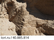 Sandstone is a fragmentary sedimentary rock, a homogeneous or layered aggregate of fragmentary grains and grains of sand bound by any mineral substance, cement. Quarry natural yellow sand wall. Стоковое фото, фотограф Юлия Петровская / Фотобанк Лори