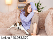 Sad depressed young adult woman crying alone at home, upset. Стоковое фото, фотограф Гладских Татьяна / Фотобанк Лори