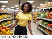 Attractive young black woman working in a supermarket, wearing a yellow shirt and dark trousers. Black Women owning small business posing looking at the camera with hand crossed. Business concept. Стоковая иллюстрация, иллюстратор Sergey Grishin / Фотобанк Лори