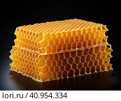 Golden wax honeycombs with honey lie on a shiny black background. Created by AI. Стоковое AI-изображение, AI-художник Ярославский Максим / Фотобанк Лори