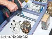 The electrician performs the installation and configuration of high-voltage equipment. Стоковое фото, фотограф Стас Пересыпкин / Фотобанк Лори