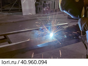 Man processes metal with gas electric welding. Стоковое фото, фотограф Стас Пересыпкин / Фотобанк Лори