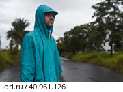 Depressive concept with lonely man in raincoat standing on wet road under rain close up. Стоковое фото, фотограф Татьяна Терехина / Фотобанк Лори
