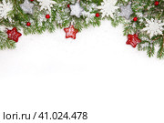Christmas border with fir branches, decorations, berries and snowflakes. New year border isolated on white, composed of fresh fir branches and ornaments in red and silver. Стоковое фото, фотограф Оксана Прахова / Фотобанк Лори