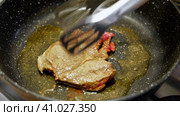 Fried fillet of beef with herb butter, peppercorns and rosemary. Frying meat steak. Closeup. Pan Searing Beef Eye Rib Steak. Filet Mignon. Making Raw seasoned angus ribeye. Food recipe background. Стоковое видео, видеограф Марина Демидюк / Фотобанк Лори