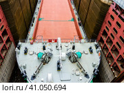 Vytegra, Russia - August 16, 2015: Close up image of cargo ship entered the White Sea-Baltic Canal Gateway. It connects the White Sea, in the Arctic Ocean, with Lake Onega. Редакционное фото, фотограф VittoriaChe / Фотобанк Лори