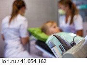 Medical equipment at dental office backdrop, patient child visits dentist doctor in medical clinic. Kid girl treats teeth, selective focus. Medicine children dentistry concept. Copy ad text space. Стоковое фото, фотограф Aleksandr Golubev / Фотобанк Лори
