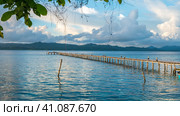 Pier of Dive Station - Kri Island. Clound above Gam in Background. Raja Ampat, Indonesia, West Papua (2016 год). Стоковое фото, фотограф Igor Tichonow / Фотобанк Лори