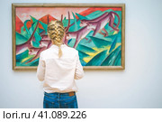 HAMBURG, GERMANY - 9 JULY 2017: Hamburg Kunsthalle art museum. Jung woman in front of painting. Редакционное фото, фотограф Igor Tichonow / Фотобанк Лори