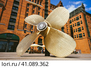 Hamburg, Germany - May 17, 2018: Giant four-blade ship propeller in front of the International Maritime Museum in Hamburg's Speicherstadt district. Редакционное фото, фотограф Igor Tichonow / Фотобанк Лори