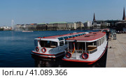 Hamburg, Germany - April 20, 2018: Cruise tourist boat on the Pier on Alster Lake, Hamburg, Germany. Редакционное фото, фотограф Igor Tichonow / Фотобанк Лори