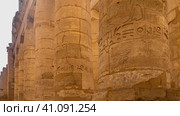Colonnade in the ancient Karnak temple of Luxor. Close-up. The stone texture of the columns, hieroglyphs, carvings are visible. Egypt (2021 год). Стоковое фото, фотограф Вера Ивановна Кубарева / Фотобанк Лори