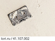 Used audio cassette lays on wet white sand. Стоковое фото, фотограф EugeneSergeev / Фотобанк Лори