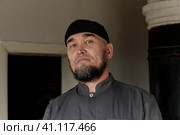 Portrait of serious senior asian man wearing skullcap. looking at camera. Стоковое фото, фотограф Ирина Кононова / Фотобанк Лори