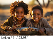 The problem of poverty and inequality. Happy african kids eating some sorghum porridge in village outdoor. Стоковое AI-изображение, AI-художник Ирина Михайличенко / Фотобанк Лори