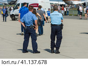 BERLIN, GERMANY - JUNE 03, 2016: The representative of the police and gendarmerie on the airfield. Ensuring public order. Exhibition ILA Berlin Air Show 2016. Редакционное фото, фотограф Sergey Kohl / Фотобанк Лори