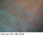 Geometric abstract background from triangles, squares and lines. Three-dimensional bulge. The volume and flex of the diagonally positioned foam material. Green, gray, orange and pink shades. Стоковое фото, фотограф Юлия Петровская / Фотобанк Лори