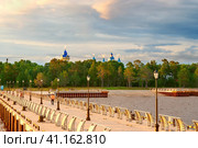 View from Lake Ladoga on the pier of Konevets Island. In the distance are the domes of the Konevets Nativity of the Virgin Mother of God Monastery. Стоковое фото, фотограф Оксана Медведева / Фотобанк Лори