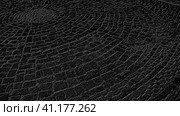 Black and gray background, reminiscent of a cobblestone street in the old town. Circular pattern. Стоковая иллюстрация, иллюстратор Юлия Петровская / Фотобанк Лори