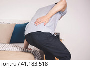 Back pain, kidney inflammation, man suffering from backache at home. Стоковое фото, фотограф Станислав Тарко / Фотобанк Лори
