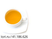 White porcelain cup with freshly brewed green tea isolated on white background. Top view. Selective focus. Белая фарфоровая чашка со свежезаваренным зеленым чаем, выделенная на белом фоне. Вид сверху. Избирательный фокус. Стоковое фото, фотограф Дмитрий Березнев / Фотобанк Лори
