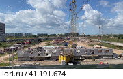 Construction site, structural steel beam build large residential buildings. Workers are engaged in laying the foundation. Стоковое видео, видеограф Ирина Старикова / Фотобанк Лори