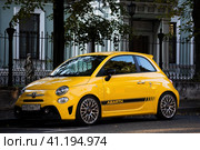 Fiat 500 Abarth parked in the street. Yellow small popular city car. Редакционное фото, фотограф Константин Григорьев / Фотобанк Лори