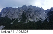 Aerial zoom out fly of Dachstein mountain top summit near Hinterer Gosausee lake Upper Austria. Стоковое фото, фотограф Igor Tichonow / Фотобанк Лори