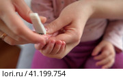 Mother use Nail Trimmer with baby hand. Mom cutting tiny fingernails. Baby care concept. How to successfully clip your baby’s nails. Closeup. Newborn hygiene. Clipping Child's Nails. Front view. 4K. Стоковое видео, видеограф Марина Демидюк / Фотобанк Лори