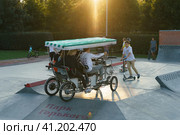 Moscow, Russia - August 28, 2019: Dangerous travel in the Gorky park. Human-powered vehicle with four wheels (quard) on the sports ground. Редакционное фото, фотограф YuryKara / Фотобанк Лори