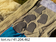 Children's feet walk on an orthopedic massage diy mat with surfaces of various shapes and tactility. grass, cones, acorns - texture details. Prevention and treatment of flat feet. Стоковое фото, фотограф Ирина Старикова / Фотобанк Лори