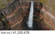 Aerial beautiful Hengifoss Waterfall, red cliff canyon and mountain river in Iceland. Стоковое видео, видеограф Igor Tichonow / Фотобанк Лори