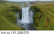 Aerial circle fly above Skogafoss waterfall on Skoga river on South Iceland in summer. Popular touri. Стоковое фото, фотограф Igor Tichonow / Фотобанк Лори