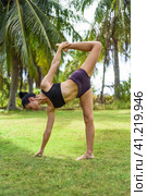 sugarcane pose or ardha chandra chapasana yoga with ukrainian woman making it outdoors. Стоковое фото, фотограф Татьяна Терехина / Фотобанк Лори