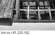 The old wooden shutters are open. Old rural style. Lattices on the windows. Summer, heat. White concrete wall. Traditional rustic architecture. Glass window. Trsic, Loznica, Serbia. Стоковое фото, фотограф Юлия Петровская / Фотобанк Лори