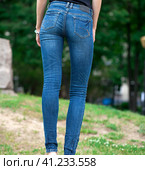 Back view of a long women legs posing with jeans. Стоковое фото, фотограф Андрей Аркуша / Фотобанк Лори