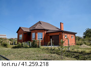 Detached house with a roof made of steel sheets. Стоковое фото, фотограф Леонид Еремейчук / Фотобанк Лори