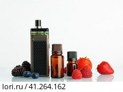 Vape smoking liquid with berry flavor close up. Стоковое фото, фотограф Сергей Толмачёв / Фотобанк Лори