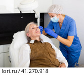 Cosmetologist doing botulotoxin injections for senior woman. Стоковое фото, фотограф Яков Филимонов / Фотобанк Лори