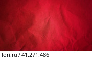 Crumpled red thick paper. Bright beautiful intense blood tint. Texture. Dark vignetting around the edges of the page. Saturated color. Bulge effect. Стоковое фото, фотограф Юлия Петровская / Фотобанк Лори